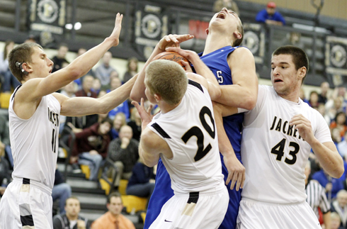 Anthony Wayne's Mark Donnal (34) battles Perrysburg's Matt Kaczinski (20) and Nate Patterson (43) for a rebound during the Jan. 8, 2013 game. The Jackets lost 71-65 in overtime.
