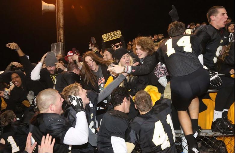 Perrysburg's football team celebrates with tudents after the 56-7 rout. THE BLADE/KATIE RAUSCH 