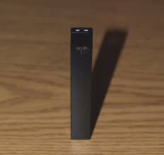 A USB-like vape on a wooden table