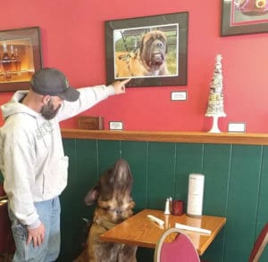 Daniel pointing out Harvey's picture on the wall at Sam B's restaurant 