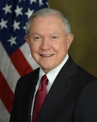 Jeff Sessions standing behind American Flag in official portrait.