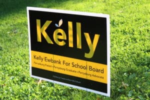 Sign reads Kelly. Kelly Ewbank For School Board. Perrysburg parent. Perrysburg graduate. Perrysburg Advocate. Paid for by Friends to Elect Kelly Ewbank