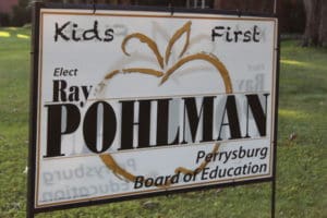 Yard sign reads Kids First. Elect Ray Pohlman Perrysburg Board of Education. Paid for by Friends of Pohlman